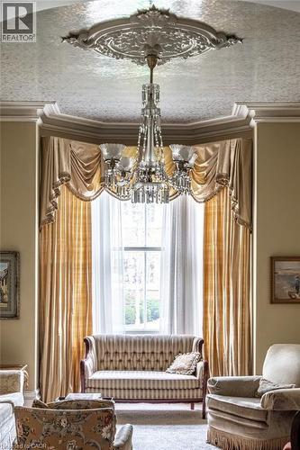 Ornate ceiling medallion featuring an elaborate crystal chandelier - 370 Hess Street S, Hamilton, ON - Indoor Photo Showing Living Room
