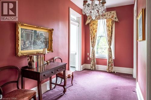Formal room featuring a crystal chandelier, floral window treatments, and high ceilings - 370 Hess Street S, Hamilton, ON - Indoor Photo Showing Other Room