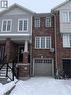 Brick facade townhome featuring a single-car garage with a paneled door - 50 Emick Drive, Ancaster, ON  - Outdoor 