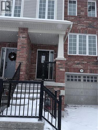 Brick and siding exterior featuring white-framed windows - 50 Emick Drive, Ancaster, ON - Outdoor