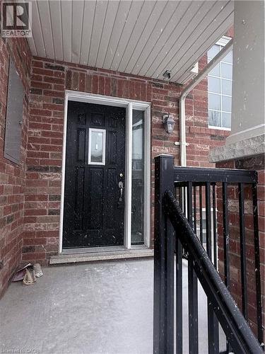 Front entrance featuring a black paneled door with decorative glass insert, a sidelight, and a brick facade - 50 Emick Drive, Ancaster, ON - Outdoor