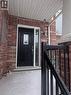 Front entrance featuring a black paneled door with decorative glass insert, a sidelight, and a brick facade - 50 Emick Drive, Ancaster, ON  - Outdoor 