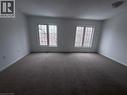 Spacious room featuring neutral carpeting and white painted walls - 50 Emick Drive, Ancaster, ON  - Indoor Photo Showing Other Room 