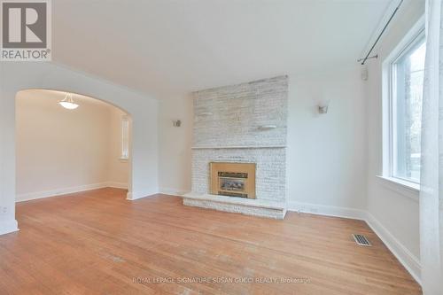 Spacious living room bright and welcoming - 388 O'Connor Drive, Toronto, ON - Indoor Photo Showing Living Room With Fireplace