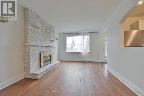 Spacious living room bright and welcoming - 388 O'Connor Drive, Toronto, ON - Indoor Photo Showing Living Room With Fireplace