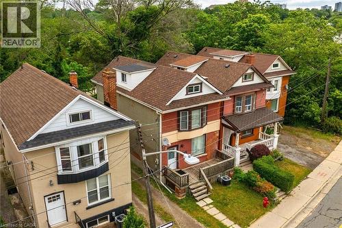 Row of residential properties featuring pitched roofs, bay windows, and covered front porches - 738 King Street W, Hamilton, ON - Outdoor