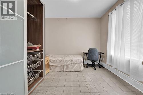Neutral tone wall paint, tile flooring, and a large window with blinds - 738 King Street W, Hamilton, ON - Indoor