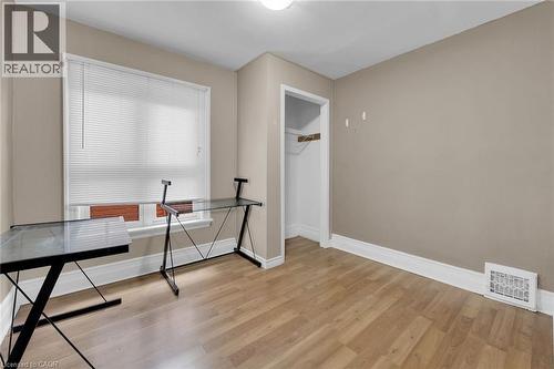 Room featuring wood-finish flooring, a window with blinds, and neutral wall paint - 738 King Street W, Hamilton, ON - Indoor