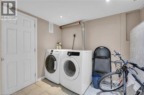 Dedicated laundry area featuring a white front-load washer and dryer, recessed lighting, and light-toned wall paint - 738 King Street W, Hamilton, ON - Indoor Photo Showing Laundry Room
