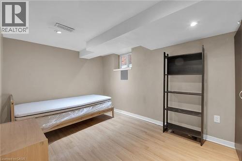 Recessed lighting illuminates this room featuring light wood-finish flooring, neutral wall tones, and an exposed ceiling beam - 738 King Street W, Hamilton, ON - Indoor Photo Showing Other Room