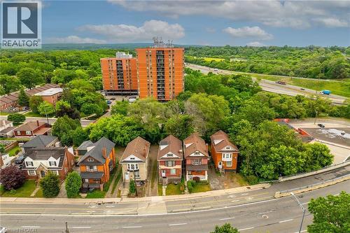 Aerial perspective showcasing residential properties surrounded by mature trees - 738 King Street W, Hamilton, ON - Outdoor With View