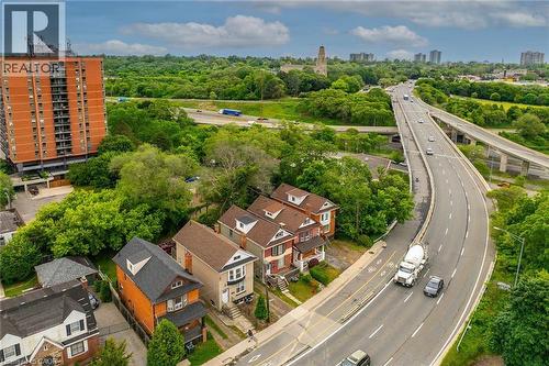 Urban landscape featuring residential properties alongside an elevated highway - 738 King Street W, Hamilton, ON - Outdoor With View
