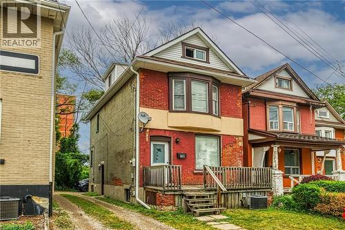 Brick exterior with bay window feature, dormer, and front porch - 738 King Street W, Hamilton, ON - Outdoor With Facade