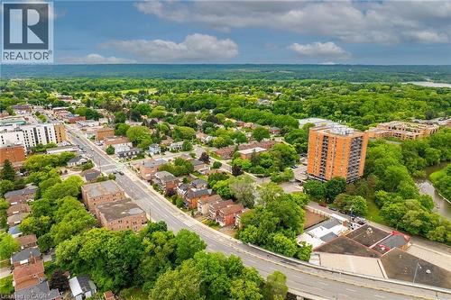 Aerial perspective showcasing a mixed-use neighborhood with residential and commercial structures - 738 King Street W, Hamilton, ON - Outdoor With View