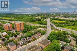 Aerial perspective showcasing an expansive urban landscape with abundant greenery, prominent roadways, and residential structures - 