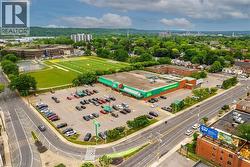 Retail building featuring a prominent corner location, expansive parking lot, and direct street access - 
