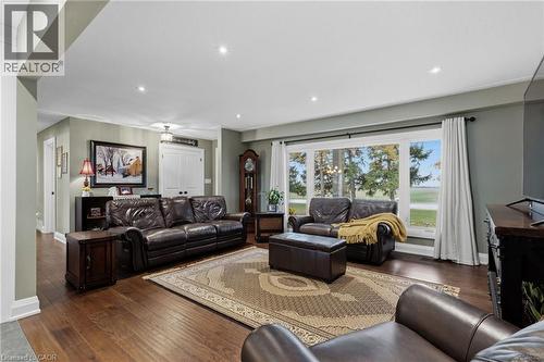 Spacious living area featuring wood-finish flooring, recessed lighting, and a large picture window with outdoor scenery - 2116 Binbrook Road E, Hamilton, ON - Indoor Photo Showing Living Room