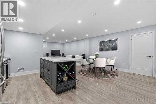 Open-concept living area with light wood-finish flooring and recessed lighting - 2116 Binbrook Road E, Hamilton, ON - Indoor