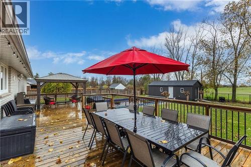Expansive wood deck with a dark-stained railing featuring a built-in pergola - 2116 Binbrook Road E, Hamilton, ON - Outdoor With Deck Patio Veranda With Exterior