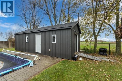 Standalone utility building featuring dark vertical siding and a shingled roof - 2116 Binbrook Road E, Hamilton, ON - Outdoor
