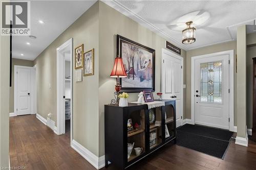 Entryway featuring a decorative transom window, wood-finish flooring, recessed lighting, crown molding, and a built-in ceiling fixture - 2116 Binbrook Road E, Hamilton, ON - Indoor Photo Showing Other Room