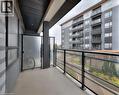 Private balcony featuring a glass railing system and durable composite flooring - 247 Northfield Drive E Unit# 207, Waterloo, ON  - Outdoor With Balcony With Exterior 