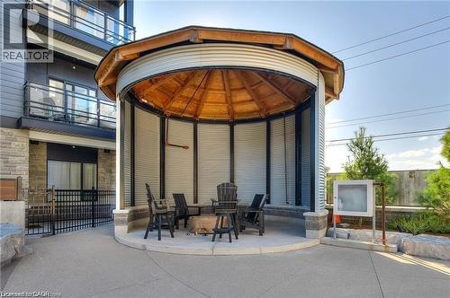Outdoor circular gazebo featuring a wood-finish ceiling, corrugated metal siding, and a concrete base - 247 Northfield Drive E Unit# 207, Waterloo, ON - Outdoor With Balcony With Exterior