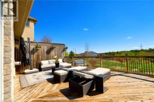 Expansive wood-finish deck with black spindle railings - 704 Zurich Drive, Waterloo, ON - Outdoor With Deck Patio Veranda With Exterior