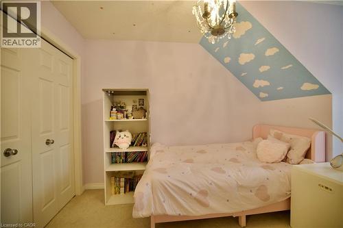 Sloping ceiling with cloud-patterned design - 704 Zurich Drive, Waterloo, ON - Indoor Photo Showing Bedroom