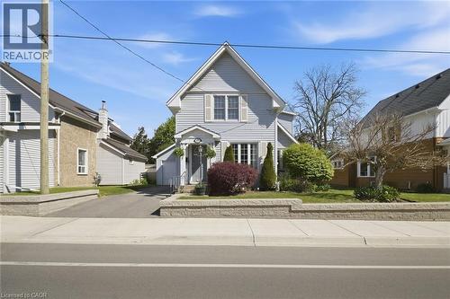 Gable-roof home featuring light-colored siding and a covered front entry - 401 West Street, Simcoe, ON - Outdoor With Facade