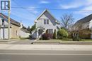 Gable-roof home featuring light-colored siding and a covered front entry - 401 West Street, Simcoe, ON  - Outdoor With Facade 
