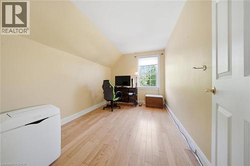 Bright interior room with wood-finish flooring, light-colored walls, and a single window providing natural illumination - 401 West Street, Simcoe, ON - Indoor