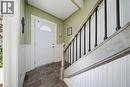 Entryway featuring a white door with an arched glass insert, slate tile flooring, and wainscoting - 401 West Street, Simcoe, ON  - Indoor Photo Showing Other Room 