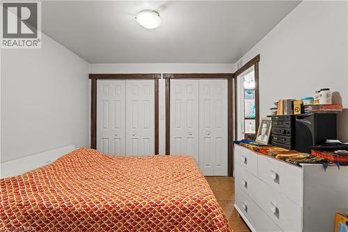 Interior room featuring white walls, white bifold closet doors with dark wood trim, and a white ceiling light fixture - 3 San Pedro Drive, Hamilton, ON - Indoor Photo Showing Bedroom