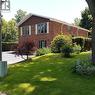 Brick exterior residence featuring a brown gable accent, multiple windows with white shutters, a paved driveway, and mature landscaping - 3 San Pedro Drive, Hamilton, ON  - Outdoor 