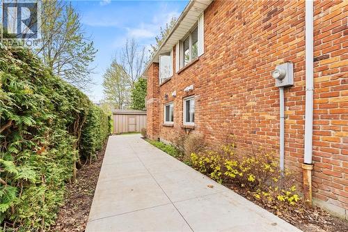 Brick exterior with multiple windows and a concrete pathway - 3 San Pedro Drive, Hamilton, ON - Outdoor