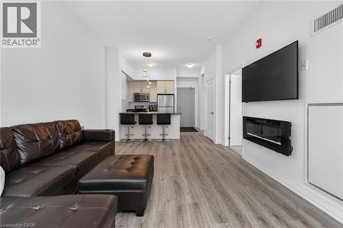10 Concord Place Unit# 516, Grimsby, ON - Indoor Photo Showing Living Room With Fireplace