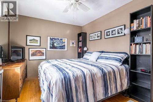 Warm-toned wall paint and hardwood flooring - 19 Chateau Court, Hamilton, ON - Indoor Photo Showing Bedroom