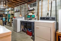 Lower-level utility area featuring exposed joists, block foundation walls, and a concrete floor - 