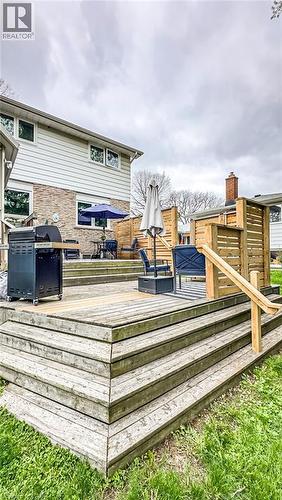 Multi-level wooden deck featuring integrated privacy screens and a handrail - 19 Chateau Court, Hamilton, ON - Outdoor With Deck Patio Veranda
