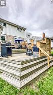 Multi-level wooden deck featuring integrated privacy screens and a handrail - 