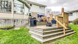 Multi-level wood deck featuring a privacy screen and integrated steps - 