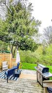 Expansive wood deck with a privacy fence and abundant mature trees - 