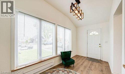 Entryway with vaulted ceiling, wood-finish flooring, and a modern geometric light fixture - 43 Adair Avenue S, Hamilton, ON - Indoor Photo Showing Other Room
