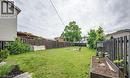 Expansive fenced backyard featuring a manicured lawn, established perimeter fencing, mature trees, and a raised garden bed - 43 Adair Avenue S, Hamilton, ON  - Outdoor 