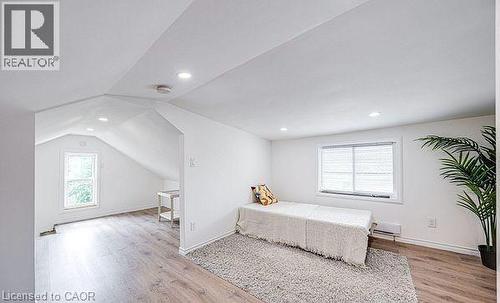 Bright attic space featuring a large window, recessed lighting, and wood-finish flooring - 43 Adair Avenue S, Hamilton, ON - Indoor