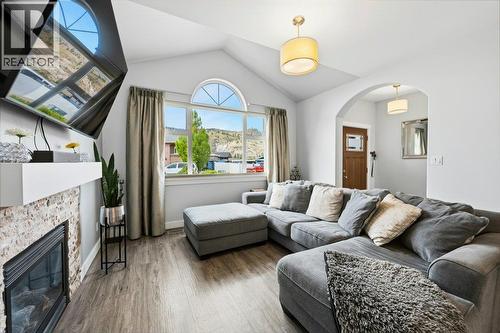 Living room with vaulted ceiling - 6925 Chardonnay Place, Oliver, BC - Indoor Photo Showing Living Room With Fireplace