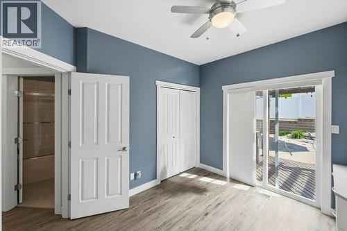Bedroom with murphy bed & access to back yard - 6925 Chardonnay Place, Oliver, BC - Indoor Photo Showing Other Room