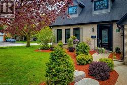 Stone brick exterior with dark trim windows and a charcoal shingled roof - 