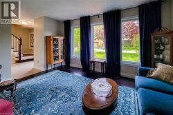 Hardwood-finish flooring throughout, complemented by a broad area rug - 